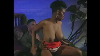 Zwarte kerel likt de harige kut van ebony babe en neukt haar hondje stijl op de stoel